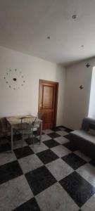 a living room with a table and a couch at Silvia Butterfly Flat in Genoa