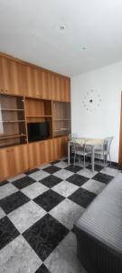 a room with a checkered floor and a table and chairs at Silvia Butterfly Flat in Genoa +22 photos