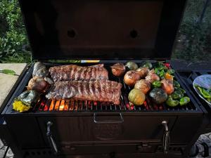 a grill with meat and vegetables on it at Hillshouse2はなれ in Tokoname