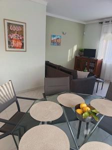 a living room with a glass table and chairs at Casa del Llimoner in L'Escala