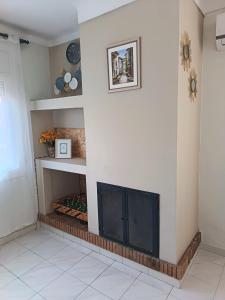 a living room with a fireplace in the corner at Casa del Llimoner in L'Escala +18 photos