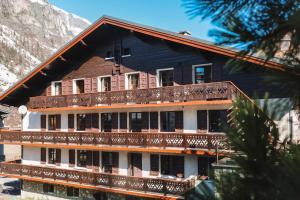 a large building with balconies on the side of it at Hotel Le Genepy in Tignes