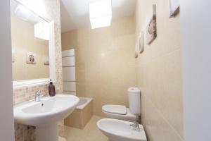 a bathroom with a sink and a toilet and a mirror at La Casa del Columpio, Comillas in Comillas +9 photos