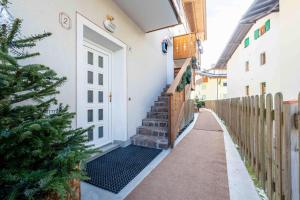 a stairway with a white door and a fence at Cesa Primula in Canazei