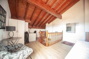 a bedroom with a bed and a wooden ceiling at La Casa del Columpio, Comillas in Comillas