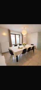 a large dining room with a table and chairs at Les Lilas in Marche-en-Famenne