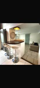a kitchen with a table and a clock on the wall at Les Lilas in Marche-en-Famenne +9 photos
