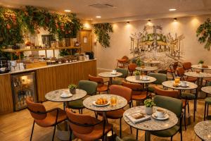 a restaurant with tables and chairs and a counter at Bobo's hotel in Paris