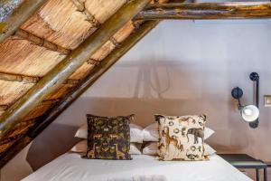 a bedroom with a bed in a attic at Little Orvyll's Studio- Near Kruger National Park, you can add up to six guests at our Larger Property Croc Orvyll's Kruger Lodge and all stay in one location in Marloth Park