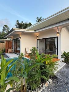 a house with a swimming pool in front of it at Srithanu Escape 1 in Srithanu