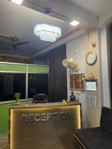 an office with a reception desk and a clock on the wall at Hotel Heritage in Varanasi