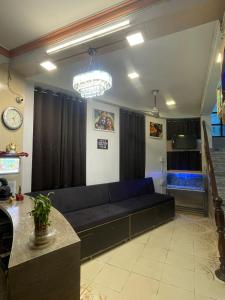 a living room with a blue couch in a room at Hotel Heritage in Varanasi