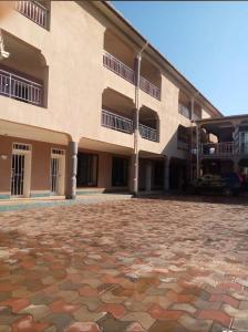 a large building with a stone ground in front of it at Sefitel in Lubumbashi