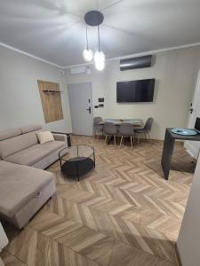a living room with a couch and a table at Apartament Mickiewicza 3 in Września +5 photos