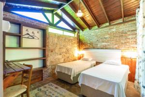 two beds in a room with a brick wall at Amazon Petite Palace in Selçuk +41 photos