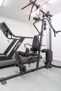 a gym with a treadmill and a elliptical machine at Esplanada Studios in Genk