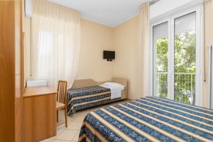 a hotel room with two beds and a window at Hotel Bridge in Rimini +137 photos