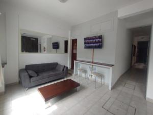 a living room with a couch and a table and chairs at PASEO GüEMES HOTEL in Salta