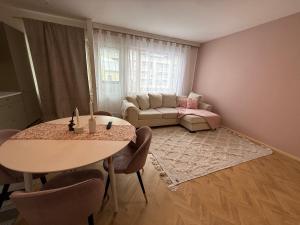 a living room with a table and a couch at Central Kauppakatu Apartment in Joensuu