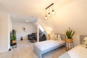 a bedroom with a bed and a living room at EasyGoing Switch Streaming schönes Apartment 6 Personen in Arnsberg