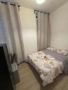 a bedroom with a bed and a television in it at hôtel des reformés in Marseille