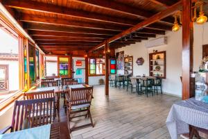 a restaurant with wooden floors and tables and chairs at Amazon Petite Palace in Selçuk