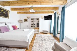 a bedroom with two beds and a couch at Casa Baritiu - budget in Braşov