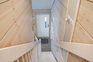 a hallway with wood paneled walls and a staircase at Villa Breikki Himos - Alpha & Bravo Incl WiFi, Sauna, Jacuzzi for extra fee in Jämsä