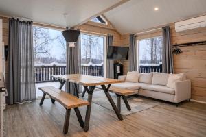 a living room with a couch and a table at Villa Breikki Himos - Alpha & Bravo Incl WiFi, Sauna, Jacuzzi for extra fee in Jämsä