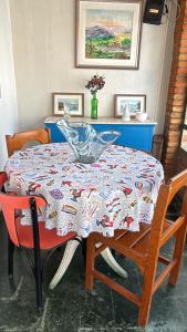 a table with a glass bowl on top of it at Romas House Hospedagem Itu in Itu