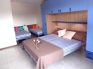 a bedroom with two beds and a table at Residence Silver Sail in Bibione +17 photos