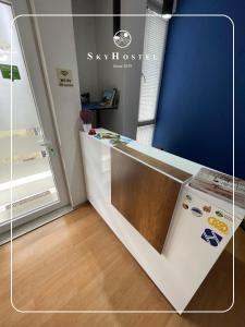 a kitchen with a counter with a refrigerator at Sky Hostel in Peje