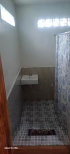 a bathroom with a sink and a shower at BougenVille in Labu Pumi +4 photos