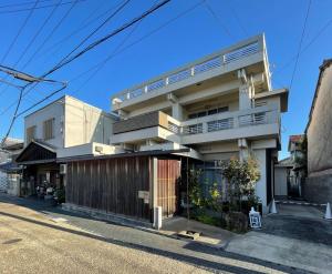 a house on the side of a street at 古街のアトリエ in Utazu