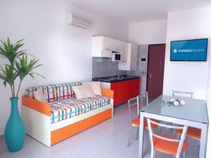 a living room with a couch and a table at Residence Silver Sail in Bibione