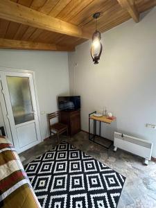 a living room with a table and a rug at Eco Garden Dilijan in Dilijan
