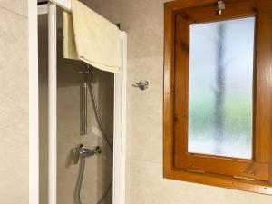 a shower with a glass door and a window at Calsina Baix 2H in Pals