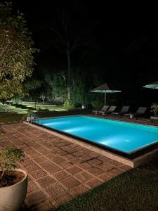 a swimming pool in a yard at night at Maho Boutique Hotel in Anuradhapura