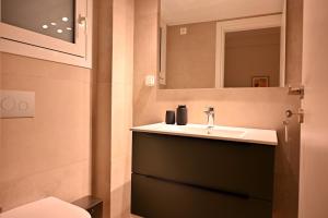 a bathroom with a sink and a mirror at Brand New! Fresh Kolonaki Studio in Athens