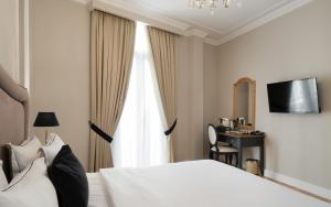 a bedroom with a white bed and a window at EV 11 Athens in Athens