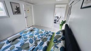 a bedroom with a bed with a blue and white comforter at Logement - maison d'hôtes Communay in Communay