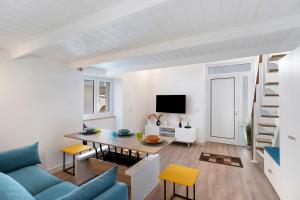 a living room with a blue couch and a table at Casa Quattrocchi in Barano d'Ischia
