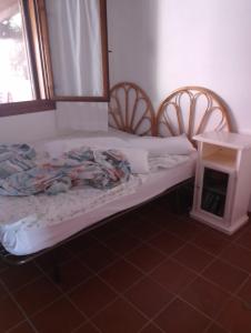a bed in a room with two chairs and a table at Residence Costa Caddu San Teodoro in Porto Ottiolu