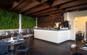 a restaurant with tables and chairs and a counter at EV 11 Athens in Athens