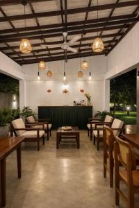 a large room with tables and chairs and lights at Maho Boutique Hotel in Anuradhapura