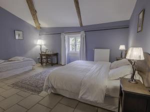 a bedroom with a large white bed and a window at La Moutière in Colonzelle