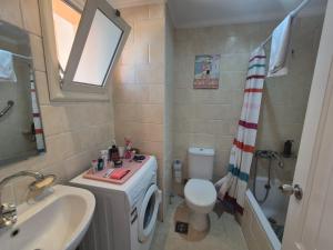 a bathroom with a sink and a toilet and a shower at K31 Peaceful 2 Bedrooms Nile Resort Flat in Luxor in Luxor +7 photos