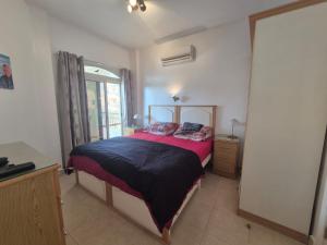 a bedroom with a large bed and a window at K31 Peaceful 2 Bedrooms Nile Resort Flat in Luxor in Luxor