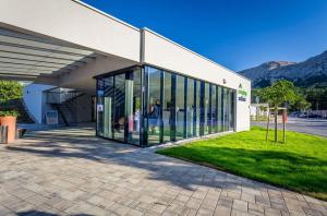 a building with large glass doors on the side of it at Camping Baska in Krk