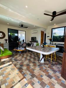 a living room with a table on a tiled floor at Private Beach House in AguaBlanca Peaceful Getaway in Playa Agua Blanca